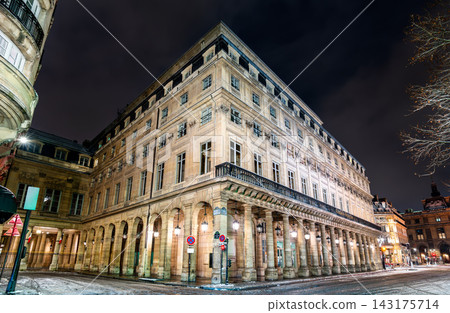Historic facade and illuminated colonnade of the Palais-Royal Salle Richelieu theater building on a winter night in Paris, France. Historic facade and illuminated colonnade of the Palais-Royal Salle Richelieu theater building on a winter night in Paris, France. 143175714