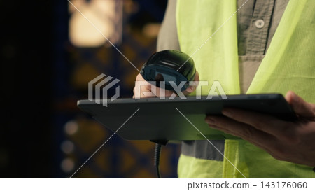 Professional staff scanning barcodes during order fulfillment process. Warehouse management system overseeing inventory for reliable e-commerce shipping and global delivery operations. Professional staff scanning barcodes during order fulfillment process. Warehouse management system overseeing inventory for reliable e-commerce shipping and global delivery operations. 143176060