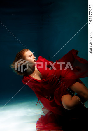 Underwater female subject with luminous skin and flowing attire Underwater female subject with luminous skin and flowing attire 143177083