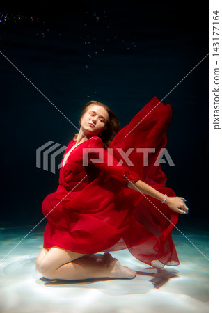 High fashion shot featuring flowing red dress and shimmering reflections High fashion shot featuring flowing red dress and shimmering reflections 143177164