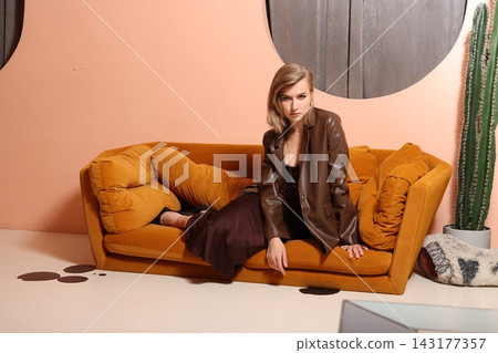 Sophisticated woman resting on warm decorative setting with accessories 143177357