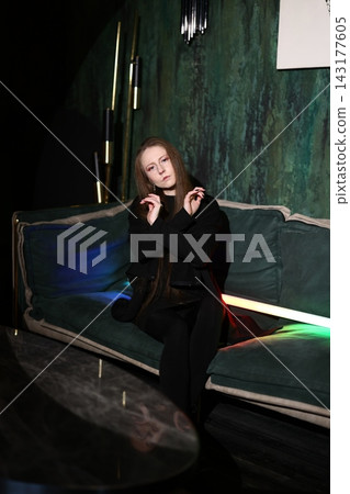 Caucasian woman on sofa exuding contemporary glamour and confidence Caucasian woman on sofa exuding contemporary glamour and confidence 143177605