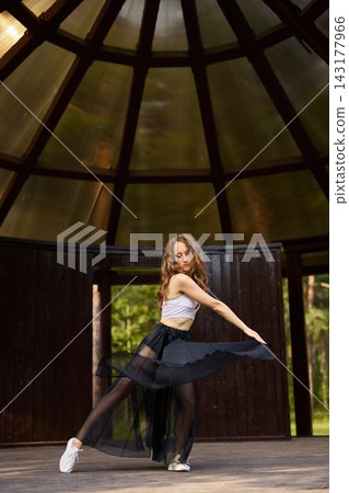 Caucasian dancer practicing mindful movement for wellness Caucasian dancer practicing mindful movement for wellness 143177966