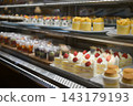 Cakes lined up at a cake shop 143179193