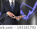 A man holding a tablet and a stock price chart. 143181792