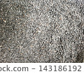 High angle close up view of black sesame seeds creating textured background for healthy culinary seasoning or traditional food garnish preparation usage. 143186192