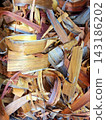 Multicolored thin wood shavings and bark chips showing layered organic texture for herbal medicine and traditional health remedies background display. 143186202