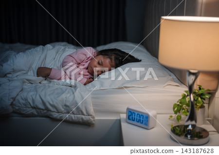 preschool child girl sleeping on bed at night preschool child girl sleeping on bed at night 143187628
