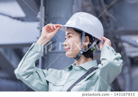 商業:身著工作服的女子正在調整頭盔。拍攝協助單位:電波學園教育集團、東京電子學院 商業:身著工作服的女子正在調整頭盔。拍攝協助單位:電波學園教育集團、東京電子學院 143187933