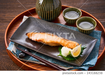 Grilled salmon, salted salmon with grated daikon radish, and sake for an evening drink. Grilled salmon, salted salmon with grated daikon radish, and sake for an evening drink. 143188238