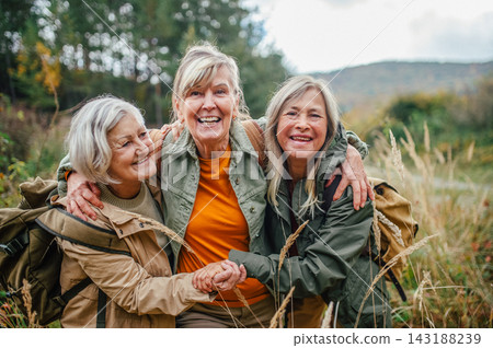 Group of mature female friends enjoying countryside walk. Group of mature female friends enjoying countryside walk. 143188239