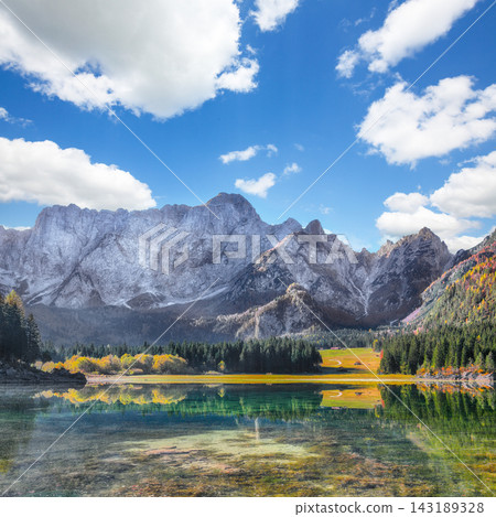 Fabulous view of Fusine lake with Mangart peak on background. Fabulous view of Fusine lake with Mangart peak on background. 143189328