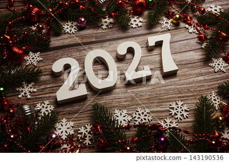 2027 Happy New Year and Christmas decoration on wooden background 143190536