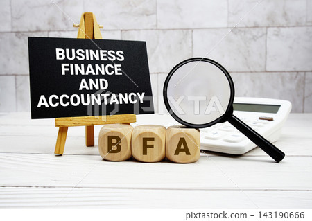 BFA Business Finance and Accountancy text with calculator magnifying glass and on wooden background BFA Business Finance and Accountancy text with calculator magnifying glass and on wooden background 143190666