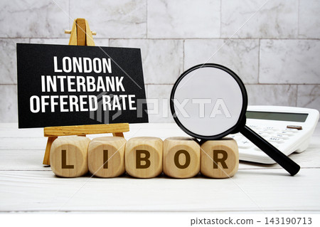 LIBOR London Interbank Offered Rate text with calculator magnifying glass and on wooden background LIBOR London Interbank Offered Rate text with calculator magnifying glass and on wooden background 143190713