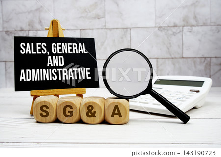 SG&A Sales, General, and Administrative text with calculator magnifying glass and on wooden background SG&A Sales, General, and Administrative text with calculator magnifying glass and on wooden background 143190723