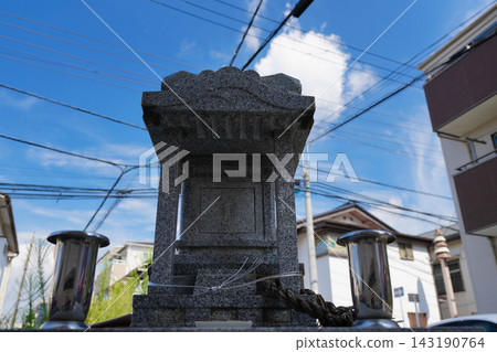A small shrine on a street corner 143190764