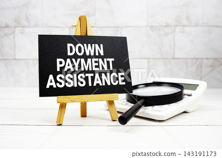 Down Payment Assistance text with calculator and magnifying glass Down Payment Assistance text with calculator and magnifying glass 143191173