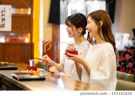 兩個女人在一家酒吧用餐 143191828