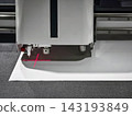 Machine cutting material with laser at a workshop in a factory setting 143193849