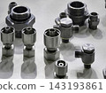 Various metal fittings arranged on a table showing different shapes and sizes commonly used in plumbing 143193861