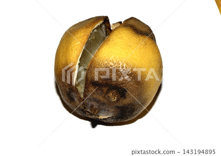 A mouldy unedible rotten lemon fruit on white background A mouldy unedible rotten lemon fruit on white background 143194895