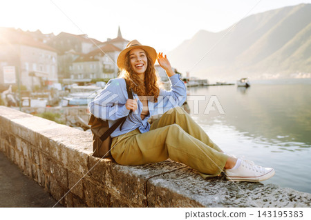 Young woman enjoying the views amazing landscape during vacation. Back view. Lifestyle, travel. 143195383