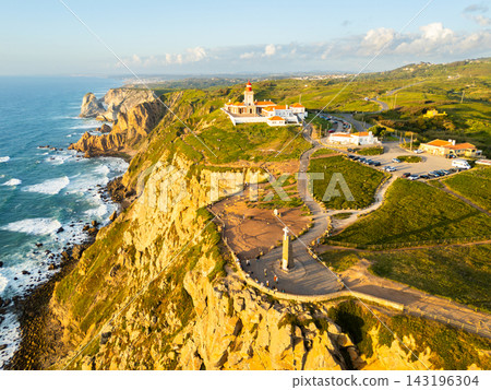 Cabo da Roca at Sunset. Cliffs, Lighthouse and Cross. Portugal. Aerial View Cabo da Roca at Sunset. Cliffs, Lighthouse and Cross. Portugal. Aerial View 143196304