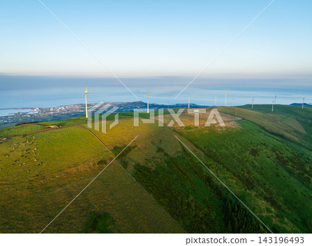 Aerial view of a wind farm on green hills in Terceira Island at sunset. Azores Aerial view of a wind farm on green hills in Terceira Island at sunset. Azores 143196493