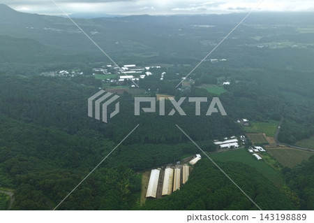 Aerial photograph capturing farmland and large-scale agricultural facilities in Ebino City, Miyazaki Prefecture. 143198889