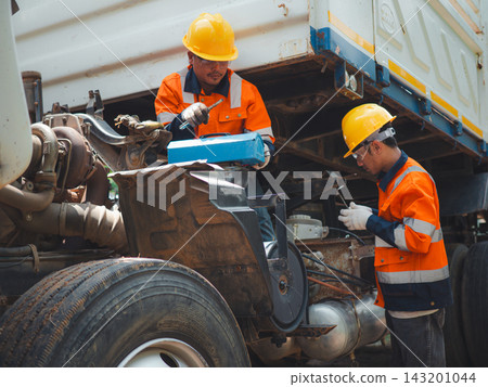 Two Male Mechanics Opening Toolbox Repairing Commercial Truck Engine Maintenance Two Male Mechanics Opening Toolbox Repairing Commercial Truck Engine Maintenance 143201044