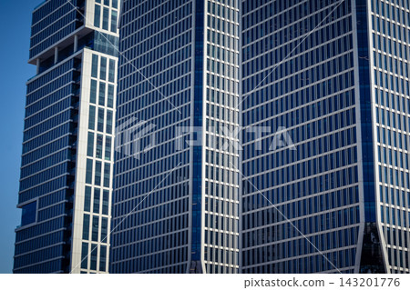 Vertical architectural perspective of modern glass skyscrapers in the metropolitan district Vertical architectural perspective of modern glass skyscrapers in the metropolitan district 143201776