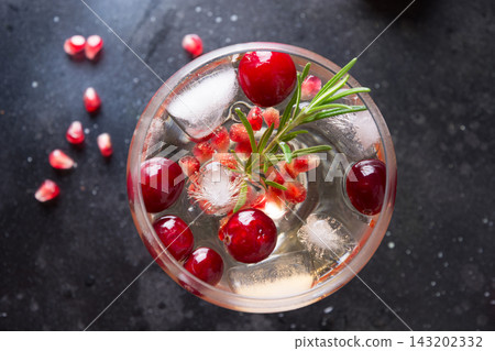 Pomegranate Christmas cocktail with rosemary, club soda. Pomegranate Christmas cocktail with rosemary, club soda. 143202332
