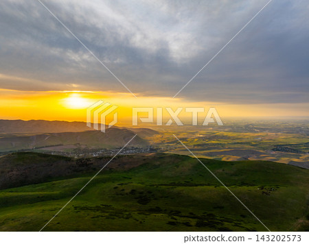 Aerial View of Golden Sunset Over Rolling Hills and Valley Town Aerial View of Golden Sunset Over Rolling Hills and Valley Town 143202573