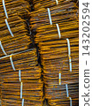 Close-up of Rusty Bent Rebar Bundles Secured with Straps 143202594
