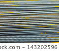 Stack of Metal Rebar Rods with Yellow Markings 143202596