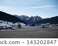 Wide landscape shot of Gosau village surrounded by snow covered Gosaukamm alpine peaks and pine forest in winter. Alpine village in Salzkammergut, Austria. 143202847