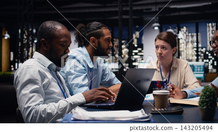 Business manager leading multiracial team, fostering teamwork and positive office culture. Management executive in boardroom supervising administrative staff, delegating tasks and reviewing KPIs. 143205494