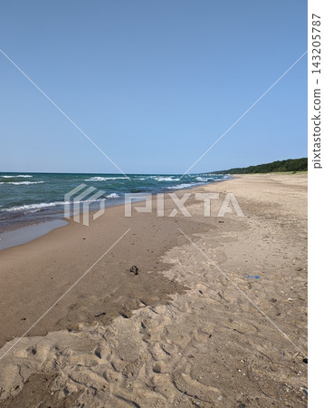 Serene Beach at Indiana Dunes National Park with Gentle Waves and Clear Blue Sky Serene Beach at Indiana Dunes National Park with Gentle Waves and Clear Blue Sky 143205787