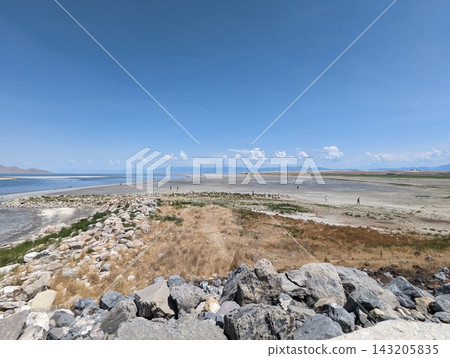 Expansive view of the Great Salt Lake shoreline under a bright blue sky. Expansive view of the Great Salt Lake shoreline under a bright blue sky. 143205835