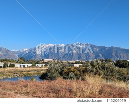 Scenic view of Salt Lake City with mountains in the background on a clear day. Scenic view of Salt Lake City with mountains in the background on a clear day. 143206059