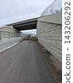Tumbleweeds piled up on a path under a highway overpass in Utah, USA 143206292