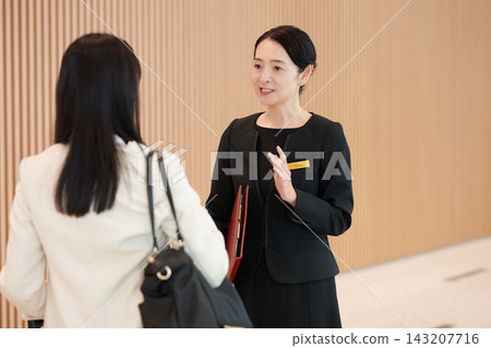 Female staff members who greet and serve customers with a smile at facilities and offices. Female staff members who greet and serve customers with a smile at facilities and offices. 143207716