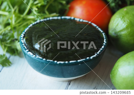Salsa verde made from fresh ingredients sits on a wooden table Salsa verde made from fresh ingredients sits on a wooden table 143209685