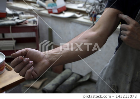 Carpenter Working in a Woodworking Factory Carpenter Working in a Woodworking Factory 143213078