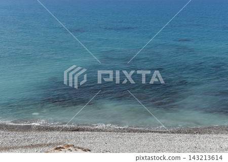 Pebble shoreline meeting clear turquoise Mediterranean waters, Cyprus 143213614
