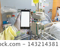 A gloved healthcare worker holds smartphone blank white screen hospital room medical equipment the background 143214381