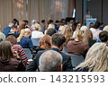 Seminar participants seen from behind in seated rows 143215593