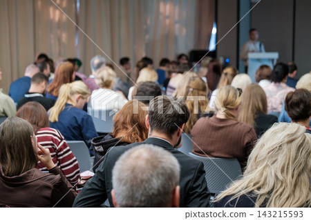 Seminar participants seen from behind in seated rows 143215593