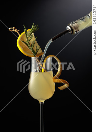 Limoncello is poured into a glass. 143215754